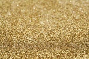 guld gyllene damm gnista glitter textur jul abstrakt gnistra bakgrund. stänga upp guld gyllene damm gnista glitter textur jul abstrakt gnistra bakgrund. guld gyllene bokeh glitter foto