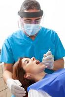 skön kvinna har dental behandling på tandläkare kontor. foto