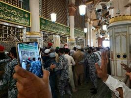 medina, saudi Arabien, april 2023 - muslim pilgrimer är gående till besök roza rasool på masjid al nabawi madinah. foto