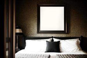 attrapp av fyrkant svart ram med säng i mörk klassisk interiör foto