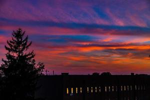 naturlig dramatisk med moln färgrik urban solnedgång med konstruktion kran foto