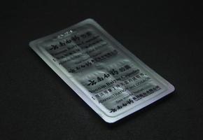 jakarta, indonesien - april 21:e, 2023 - yunan baiyao kapsel läsplatta kinesisk medicin medicinsk produkt fotografi isolerat på enkel svart bakgrund foto