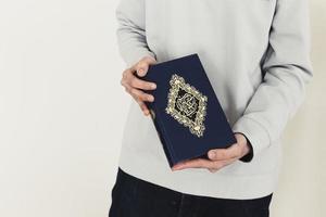 ramadankoncept med mannen som håller koranen foto