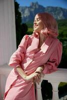 porträtt av en kvinna i en rosa klänning utomhus natur se sommar dag foto