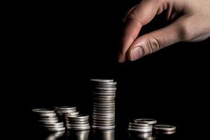 en mänsklig rörande penny silver- mynt stack för sparande eller företag investera begrepp. generativ ai. foto