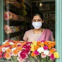 närbild porträtt av indisk blomsterhandlare kvinna bär mask i henne blommig affär, generativ ai. foto