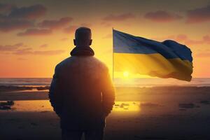 stående stark för frihet man med ukrainska flagga på solnedgång strand ai genererad foto