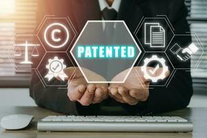 patent begrepp, person hand innehav patenterad ikon på virtuell skärm, patent upphovsrätt lag företag teknologi begrepp. foto