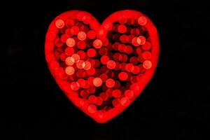 original- röd lysande hjärta på en svart bakgrund foto