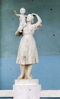 en staty av en mor och barn den där var skadad förbi beskjutning. en staty misshandlade förbi raket fragment står på de utbombade kulturell Centrum. krig i ukraina. Ukraina, irpin - Maj 06, 2023. foto