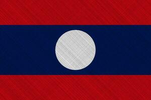 lao människors demokratisk republik flagga på en texturerad bakgrund. begrepp collage. foto