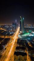 bländande natt stad skott av riyadh som visar horisont landmärken, kontor och bostads- byggnader i söder arabien. generativ ai teknologi. foto