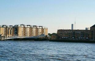 låg vinkel se av central London byggnader och flod thames på kanariefågel kaj central london. de antal fot var fångad under solnedgång över London stad av England Storbritannien på juni 08, 2023 foto