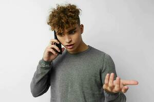 stilig kille med en telefon i hand kommunikation isolerat bakgrund foto