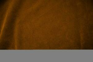 orange sammet tyg textur Begagnade som bakgrund. orange tyg bakgrund av mjuk och slät textil- material. där är Plats för text. foto
