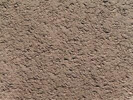 ojämn grynig textur av torr komprimerad jord eller sand av ljus gråbrun beige Färg foto