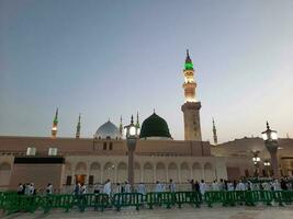 medina, saudi Arabien, Maj 2023 - skön morgon- se av masjid al nabawi, medina. besökare, gårdar utanför de moské, skön lampor, och elektronisk paraplyer kan också vara sett. foto