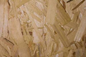 trä- naturlig rustik bakgrund. spånskiva. abstrakt textur plywood faner. ark av plywood med fragment av komprimerad sågspån foto