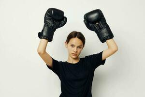 skön flicka i boxning handskar i svart byxor och en t-shirt livsstil oförändrad foto