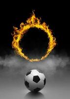 fotboll boll och ringa av brand i svart rök bakgrund foto