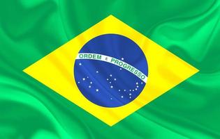 Brasilien land flagga på vågiga siden textil bakgrund foto