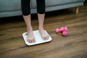 fett diet och skala fötter stående på elektronisk skalor för vikt kontrollera. mått instrument i kilogram för en diet kontrollera foto