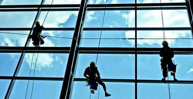 extrem arbete rengöring de fönster av byggnader på höjd foto