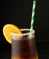 iced kaffe med orange juice i en transparent glas, uppfriskande stappla kaffe på de tabell foto