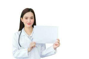 professionell ung asiatisk kvinna läkare vem bär medicinsk täcka innehar och visar vit papper till närvarande något i sjukvård begrepp isolerat på vit bakgrund. foto