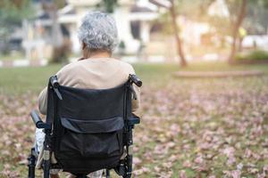 asiatisk senior eller äldre gammal damkvinna på rullstol i park, hälsosamt starkt medicinskt koncept. foto