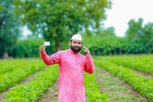 indisk jordbrukare innehav gullak i hand, sparande begrepp, Lycklig fattig jordbrukare foto