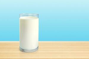 glas av mjölk på trä- tabell med blå bakgrund foto