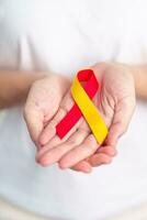 kvinna innehav röd och gul band. värld hepatit dag medvetenhet månad, 28 juli, lever cancer, gulsot, cirros, fel, förstorad, lever- encefalopati och hälsa begrepp foto