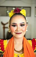 skön ansikte av en traditionell indonesiska dansare bär blommor och charmig smink innan utför foto