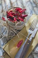 en skål av röd chili paprikor på en tabell foto