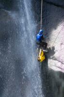 en person på en rep klättrande upp en vattenfall foto