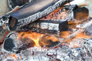 en stänga upp av en brand med trä och kol foto
