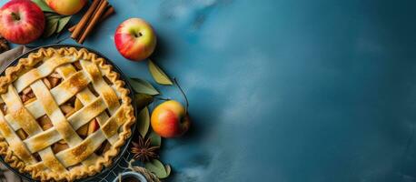 en bakgrund bild skildrar höst bakning med färsk äpplen, kryddor, och redskap på en blå tabell. foto