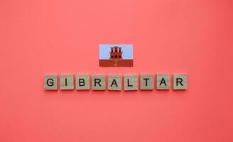 september 10, gibraltar nationell dag, flagga av gibraltar, minimalistisk baner med de inskrift i trä- brev foto