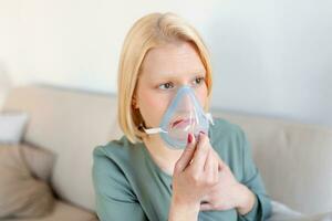 sjuk kvinna på syre mask inandning, lunginflammation coronavirus pandemisk. sjuk kvinna bär ett syre mask och genomgå behandling. covid 19 foto