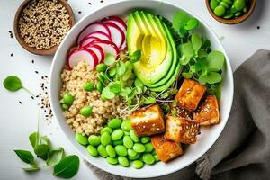 friska vegan mat. buddha skål med quinoa, friterad tofu, avokado, edamame, grön ärtor, rädisa, kål och sesam frön. vit kök tabell bakgrund, topp view.ai generativ foto