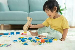 Lycklig asiatisk barn spelar och inlärning leksak block. barn är mycket Lycklig och upphetsad på Hem. barn ha en bra tid spelar, aktiviteter, utveckling, uppmärksamhet underskott hyperaktivitet oordning foto