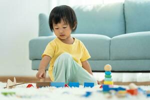 Lycklig asiatisk barn spelar och inlärning leksak block. barn är mycket Lycklig och upphetsad på Hem. barn ha en bra tid spelar, aktiviteter, utveckling, uppmärksamhet underskott hyperaktivitet oordning foto