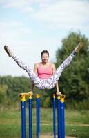 atletisk gymnast som tränar på parallella barer foto