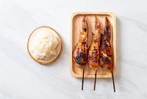 grillad eller grillad kycklingvingespett med klibbigt ris foto