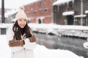 vacker ung asiatisk kvinna leende och nöjd med resor i Otaru kanal Hokkaido Japan foto