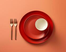 en röd tallrik gaffel och kniv på ett orange bakgrund generativ ai foto