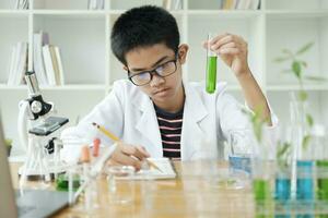 ung vetenskapsmän i verkan barn uppträdande kemi experimentera i skola laboratorium foto