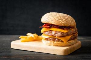 fläskhamburgare eller fläskhamburgare med ost, bacon och pommes frites foto