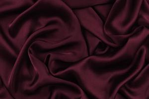 abstrakt satin silkesduk, tyg textil drapering med veck vågiga veck. med mjuka vågor, vinkar i vinden. textur av skrynkligt papper